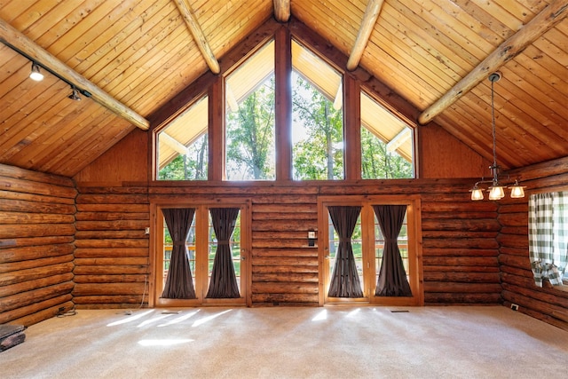 702 Jasper Ave NE, Mitchellville, IA 50169 - unfurnished living room featuring rail lighting, plenty of natural light, high vaulted ceiling, a wood ceiling with exposed beams, and carpet flooring