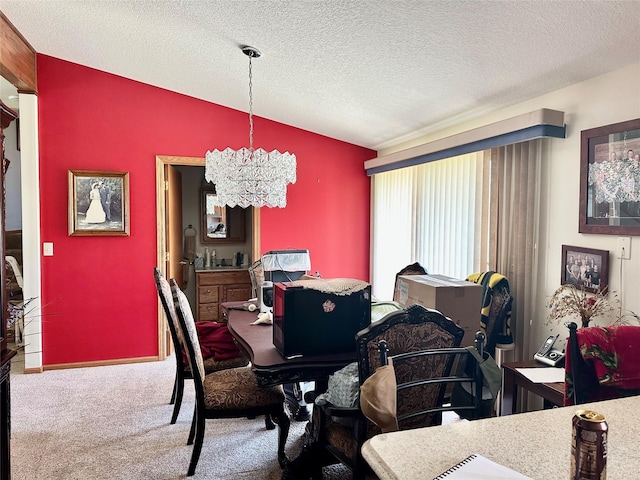 94 14th Ave, Grinnell, IA 50112 - dining room with lofted ceiling, a chandelier, carpet floors, and a textured ceiling