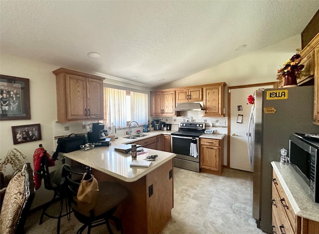 94 14th Ave, Grinnell, IA 50112 - kitchen featuring appliances with stainless steel finishes, under cabinet range hood, a peninsula, a textured ceiling, and light countertops