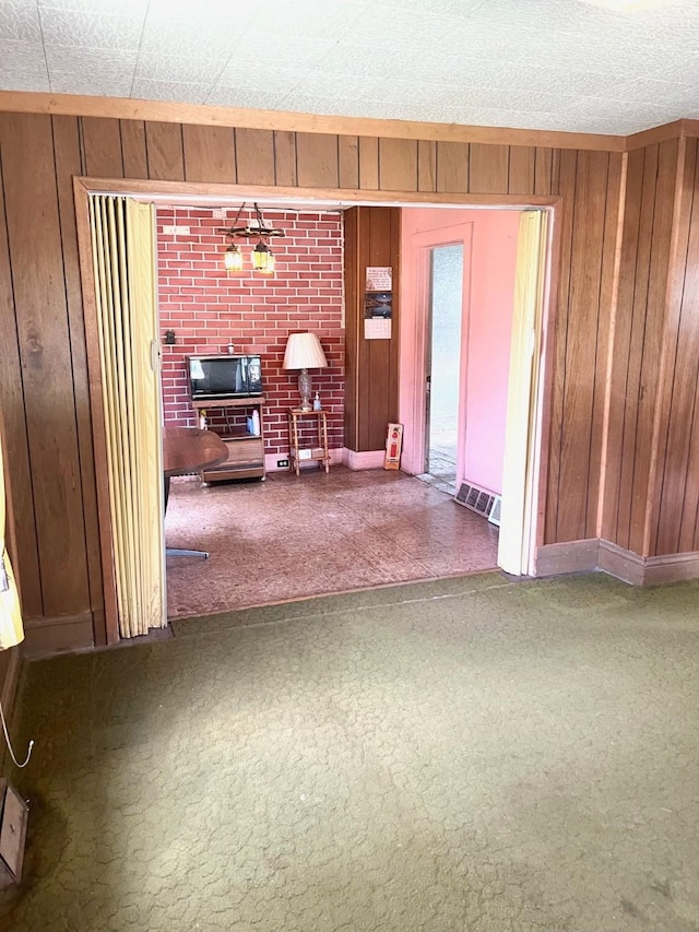 1348 Idaho St, Des Moines, IA 50316 - carpeted living room with wood walls