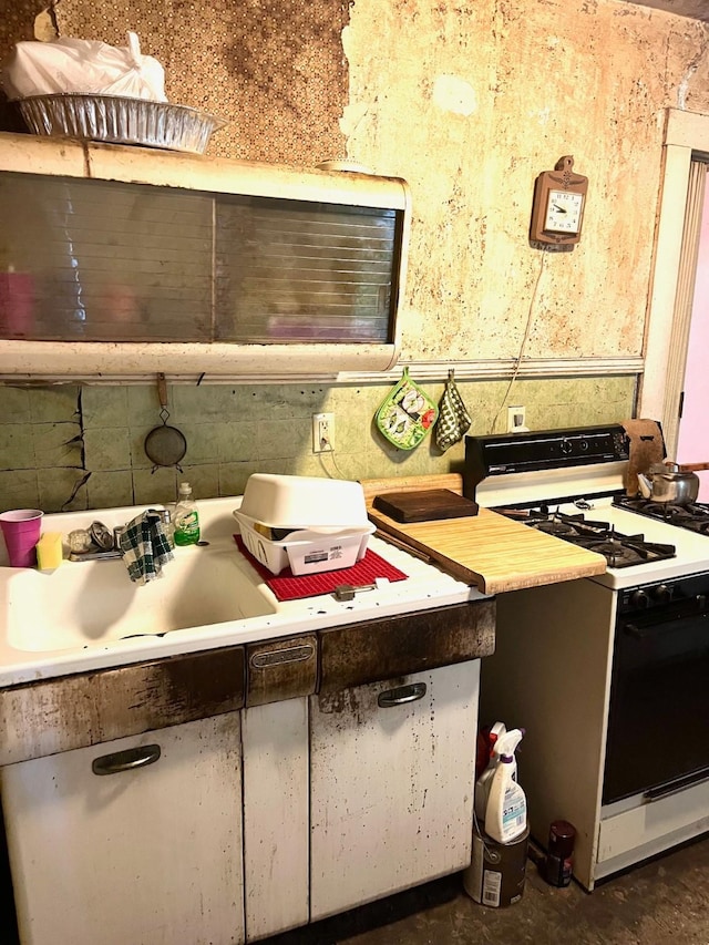 1348 Idaho St, Des Moines, IA 50316 - kitchen featuring white range with gas stovetop, light countertops, and concrete floors