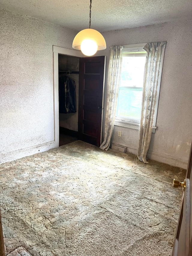 1348 Idaho St, Des Moines, IA 50316 - unfurnished dining area with carpet and a textured ceiling