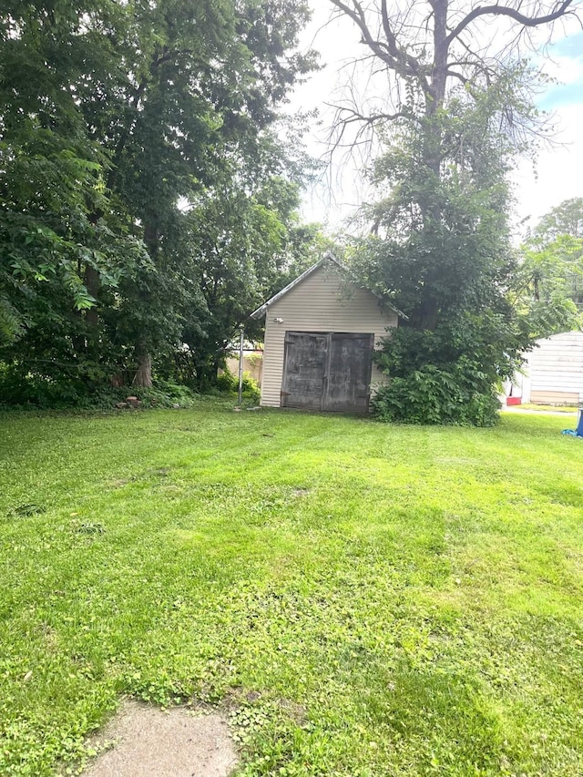 1348 Idaho St, Des Moines, IA 50316 - view of green lawn featuring a garage
