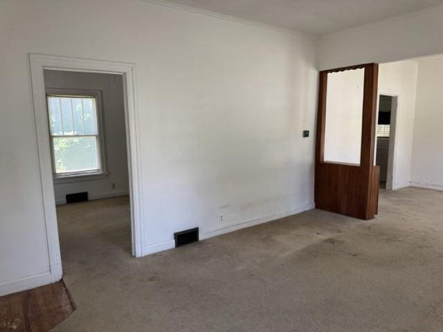 4046 4th St, Des Moines, IA 50313 - carpeted empty room featuring crown molding and baseboards