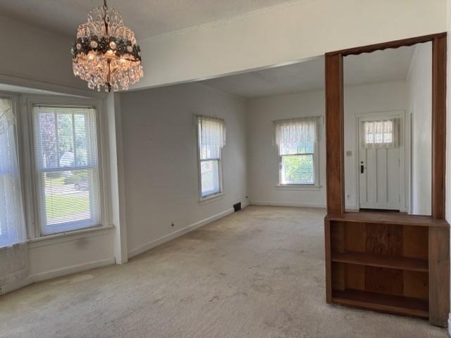 4046 4th St, Des Moines, IA 50313 - foyer entrance with a chandelier and carpet flooring