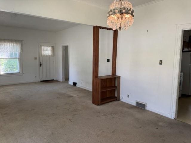 4046 4th St, Des Moines, IA 50313 - carpeted empty room featuring a chandelier and baseboards