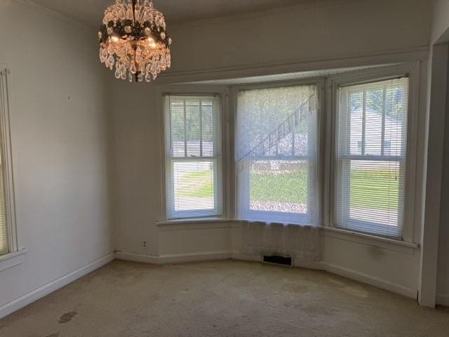 4046 4th St, Des Moines, IA 50313 - unfurnished dining area with carpet flooring and a chandelier