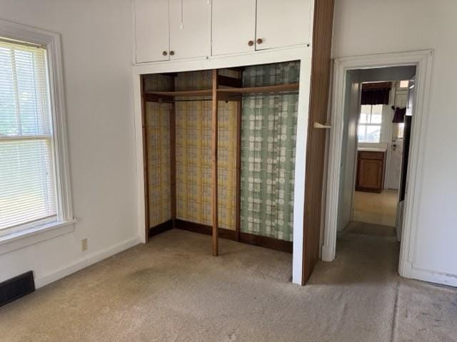 4046 4th St, Des Moines, IA 50313 - unfurnished bedroom featuring carpet and a closet