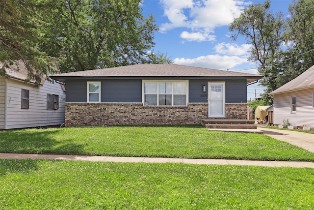 3025 Dean Ave, Des Moines, IA 50317 - view of front facade featuring brick siding, a front lawn, and roof with shingles