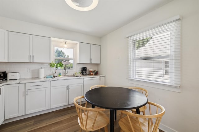 3025 Dean Ave, Des Moines, IA 50317 - kitchen featuring healthy amount of natural light, dark wood-type flooring, backsplash, and light countertops