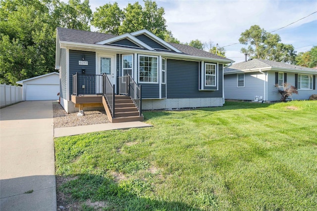 6217 Welker Ave, Des Moines, IA 50312 - view of front facade with an outbuilding, a detached garage, a front lawn, and roof with shingles