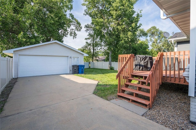 6217 Welker Ave, Des Moines, IA 50312 - view of yard featuring a wooden deck, stairway, an outdoor structure, and a garage
