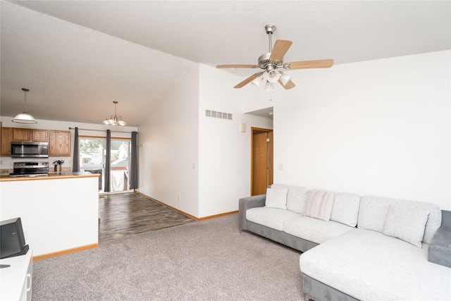 6217 Welker Ave, Des Moines, IA 50312 - living room with dark colored carpet, a chandelier, ceiling fan, and high vaulted ceiling
