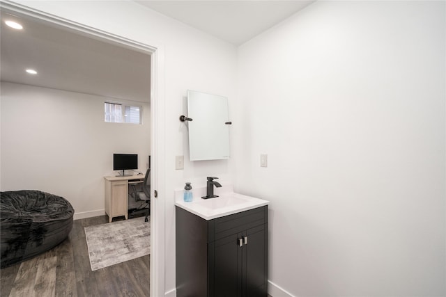 6217 Welker Ave, Des Moines, IA 50312 - bathroom with wood finished floors, vanity, and recessed lighting