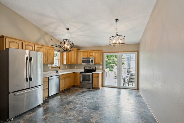 221 E Payton Ave, Des Moines, IA 50315 - kitchen with appliances with stainless steel finishes, a chandelier, light countertops, pendant lighting, and a textured ceiling