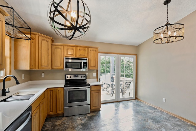 221 E Payton Ave, Des Moines, IA 50315 - kitchen featuring appliances with stainless steel finishes, a chandelier, light countertops, pendant lighting, and a textured ceiling