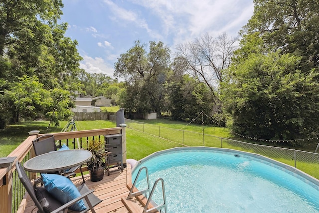 221 E Payton Ave, Des Moines, IA 50315 - view of swimming pool with a fenced backyard, a deck, and view of scattered trees