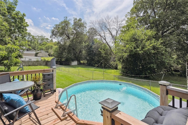 221 E Payton Ave, Des Moines, IA 50315 - view of swimming pool featuring a fenced backyard, a deck, and view of scattered trees