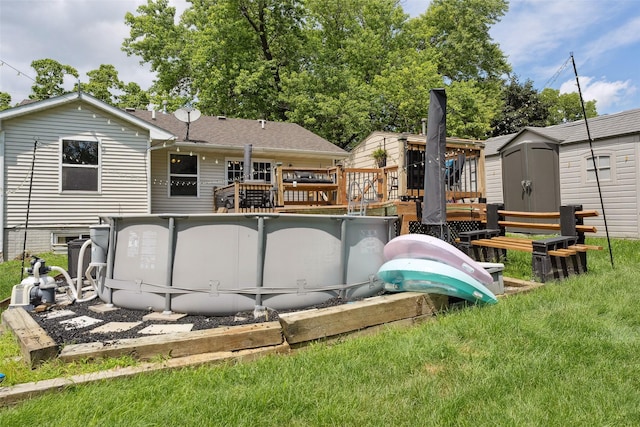 221 E Payton Ave, Des Moines, IA 50315 - rear view of property featuring a storage shed, a deck, an outdoor pool, and a yard