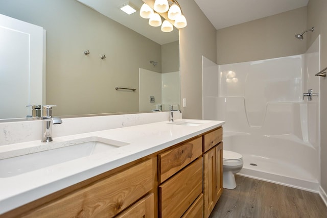 1102 Westview Dr, Huxley, IA 50124 - full bath featuring wood finished floors, double vanity, a shower, and a chandelier