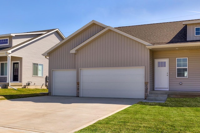 1102 Westview Dr, Huxley, IA 50124 - view of front of house featuring concrete driveway, an attached garage, roof with shingles, and a front lawn