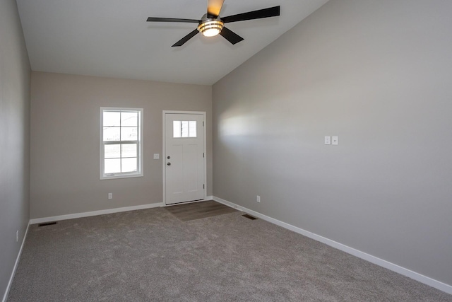 1102 Westview Dr, Huxley, IA 50124 - entrance foyer featuring dark carpet, a ceiling fan, and vaulted ceiling