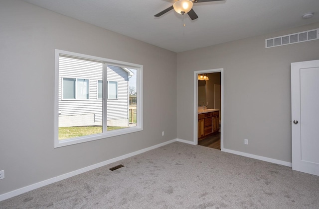 1102 Westview Dr, Huxley, IA 50124 - unfurnished bedroom with dark colored carpet, ensuite bath, and ceiling fan