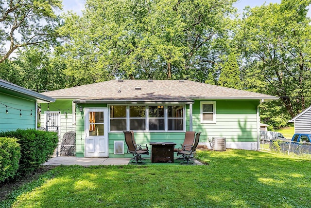 2525 27th Pl, Des Moines, IA 50310 - rear view of property with an outdoor fire pit, roof with shingles, a patio, and a sunroom
