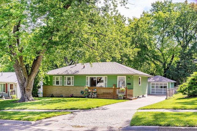 2525 27th Pl, Des Moines, IA 50310 - single story home with an outdoor structure, driveway, a detached garage, and a front yard