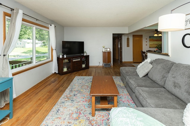 2525 27th Pl, Des Moines, IA 50310 - living room with wood finished floors, a ceiling fan, and a textured ceiling