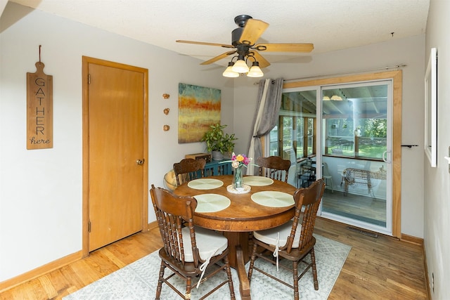 2525 27th Pl, Des Moines, IA 50310 - dining area featuring light wood-type flooring, ceiling fan, and a textured ceiling