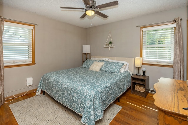 2525 27th Pl, Des Moines, IA 50310 - bedroom featuring wood finished floors, multiple windows, a ceiling fan, and a textured ceiling