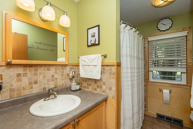 2525 27th Pl, Des Moines, IA 50310 - bathroom with vanity, a textured ceiling, backsplash, tile patterned flooring, and a shower with shower curtain