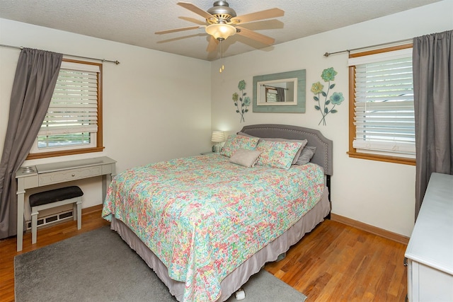2525 27th Pl, Des Moines, IA 50310 - bedroom featuring wood finished floors, a textured ceiling, and ceiling fan