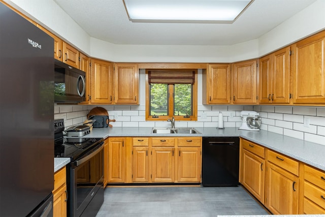 502 5th Ave SW, Altoona, IA 50009 - kitchen with black appliances, backsplash, and brown cabinetry