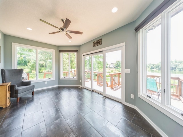 36508 Meadow Ln, Cumming, IA 50061 - sitting room featuring ceiling fan, recessed lighting, and dark tile patterned flooring