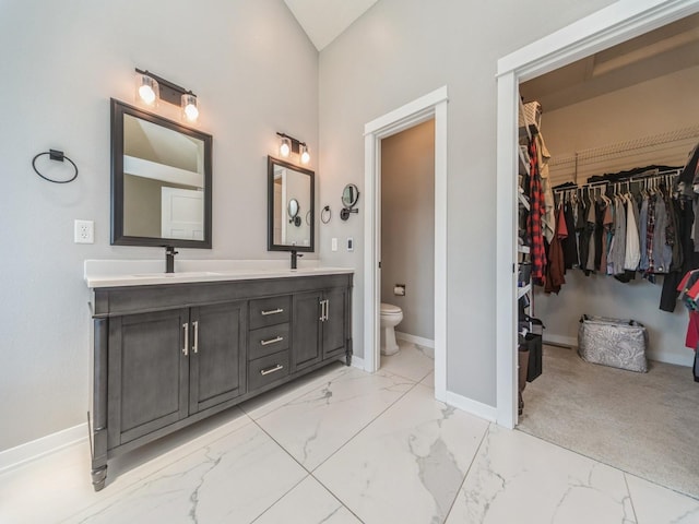 36508 Meadow Ln, Cumming, IA 50061 - bathroom with marble finish flooring, double vanity, and a walk in closet