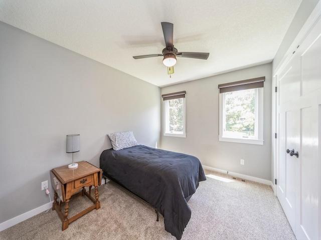 36508 Meadow Ln, Cumming, IA 50061 - bedroom with light colored carpet and a ceiling fan