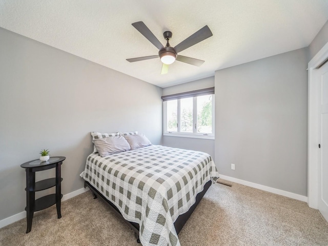 36508 Meadow Ln, Cumming, IA 50061 - carpeted bedroom with baseboards and a ceiling fan