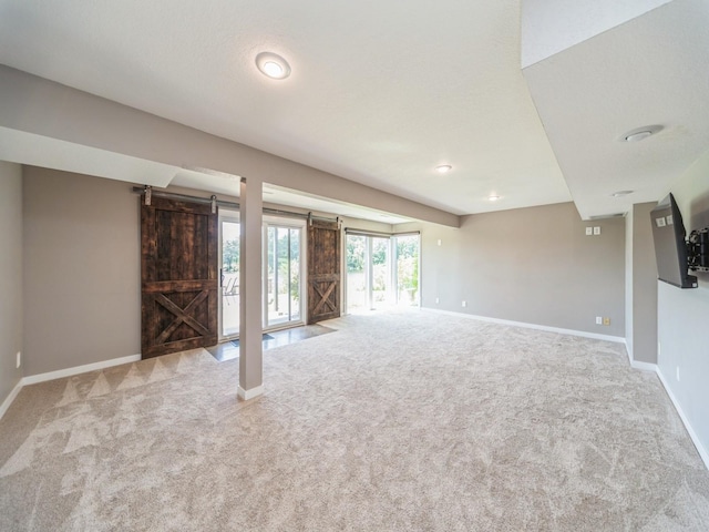 36508 Meadow Ln, Cumming, IA 50061 - spare room with carpet, a barn door, and recessed lighting