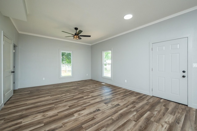 611 W 2nd St S, Newton, IA 50208 - spare room with wood finished floors, ceiling fan, and crown molding