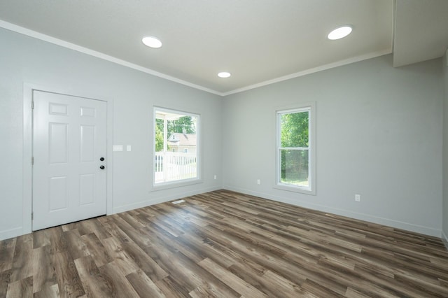 611 W 2nd St S, Newton, IA 50208 - foyer entrance featuring crown molding, plenty of natural light, wood finished floors, and recessed lighting