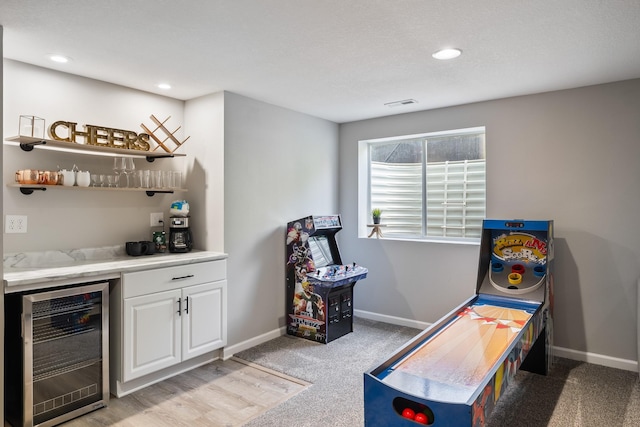 4315 E 48th St, Des Moines, IA 50317 - recreation room with wine cooler, a dry bar, light colored carpet, and recessed lighting