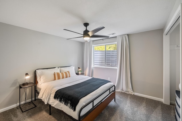 4315 E 48th St, Des Moines, IA 50317 - bedroom with dark carpet and ceiling fan