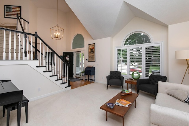 14092 Lake Pointe Dr, Clive, IA 50325 - carpeted living room with a chandelier, high vaulted ceiling, and stairs
