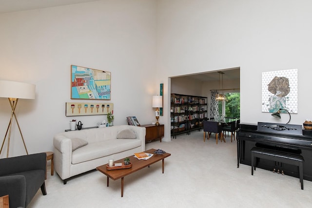 14092 Lake Pointe Dr, Clive, IA 50325 - living room with a chandelier, a towering ceiling, and light colored carpet
