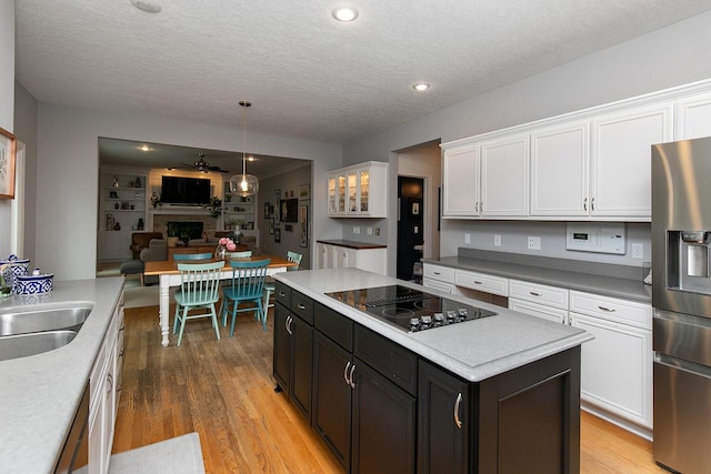 14092 Lake Pointe Dr, Clive, IA 50325 - kitchen with stainless steel refrigerator with ice dispenser, black electric cooktop, white cabinetry, a textured ceiling, and light wood-type flooring