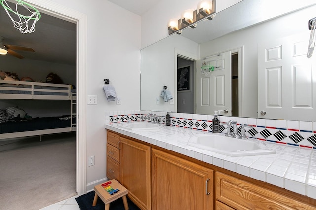 14092 Lake Pointe Dr, Clive, IA 50325 - full bathroom featuring double vanity, a ceiling fan, tasteful backsplash, and tile patterned flooring