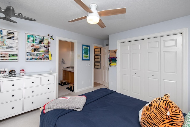 14092 Lake Pointe Dr, Clive, IA 50325 - bedroom with a closet, ceiling fan, ensuite bathroom, and a textured ceiling