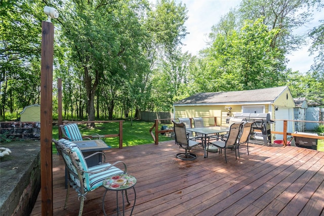 808 Bridge St, Redfield, IA 50233 - deck with outdoor dining space, a fenced backyard, and a shed